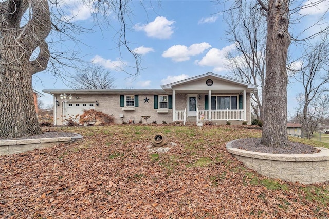 single story home featuring covered porch and a garage