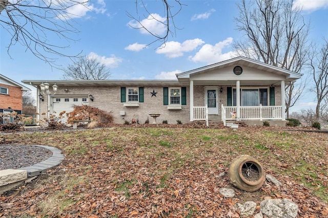 ranch-style home featuring covered porch and a garage