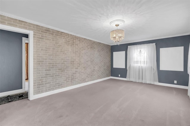 carpeted spare room featuring a chandelier, ornamental molding, and brick wall