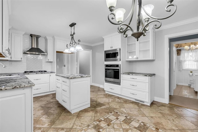 kitchen featuring white cabinets, stainless steel appliances, a kitchen island, and wall chimney exhaust hood