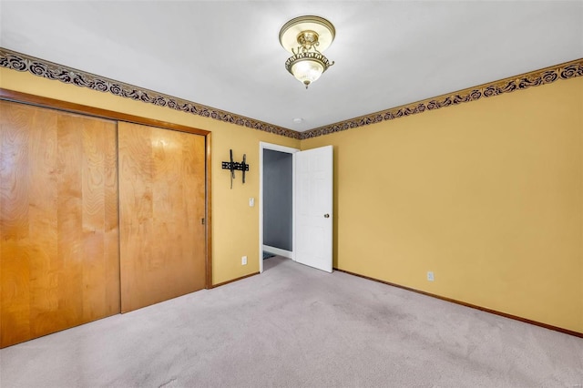 unfurnished bedroom with a closet and carpet floors