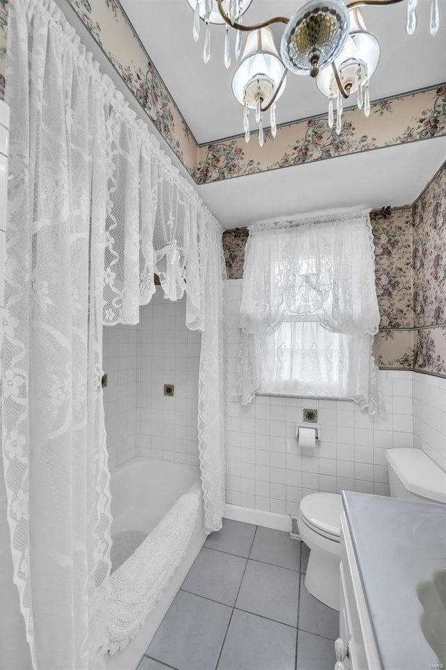 full bathroom featuring vanity, shower / bath combination with curtain, tile patterned flooring, toilet, and a chandelier