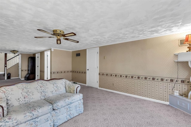 unfurnished living room featuring ceiling fan, light carpet, and a textured ceiling