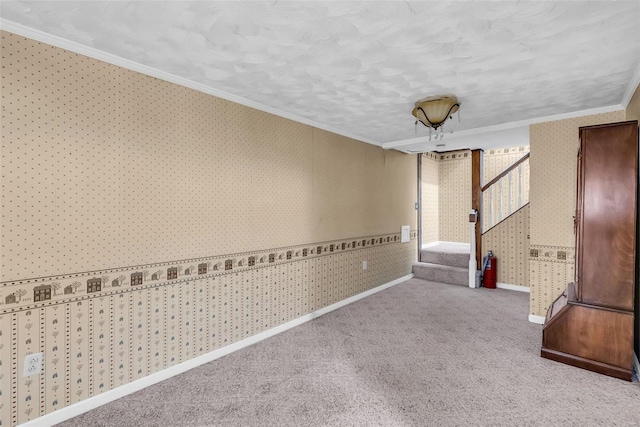 carpeted empty room with a textured ceiling and ornamental molding