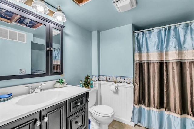 bathroom with tile patterned floors, vanity, and toilet