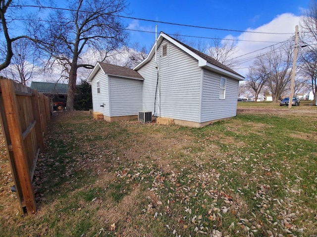 view of home's exterior with a lawn and central AC