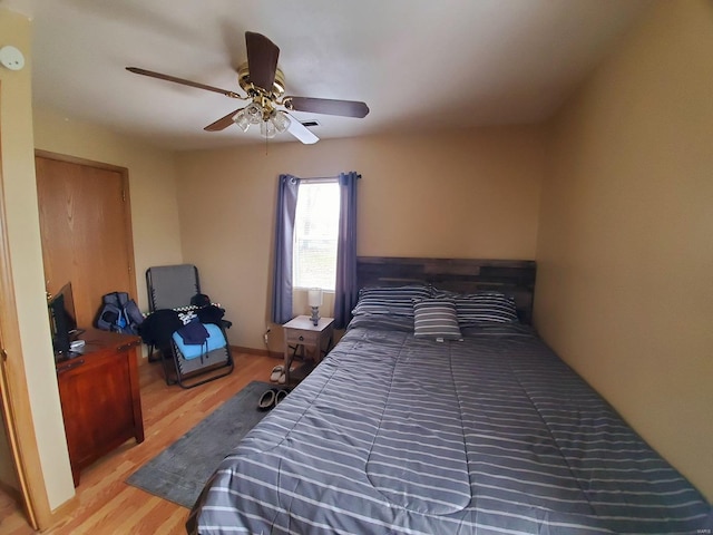 bedroom with ceiling fan and hardwood / wood-style flooring