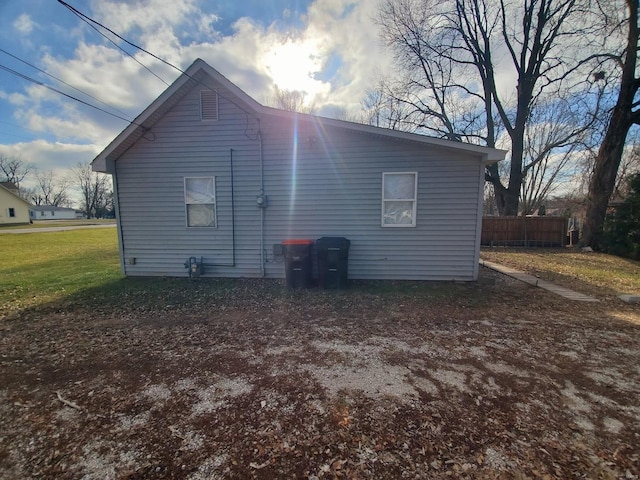 view of side of home with a lawn