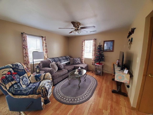 living room featuring ceiling fan and light wood-style floors