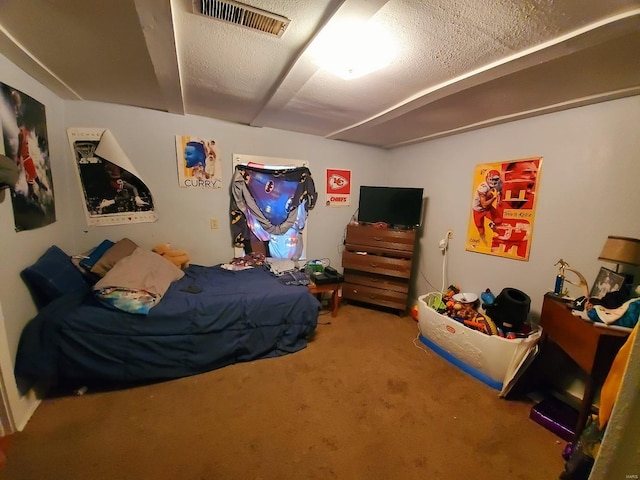 bedroom featuring carpet, visible vents, and a textured ceiling