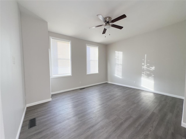 unfurnished room with ceiling fan and dark hardwood / wood-style floors