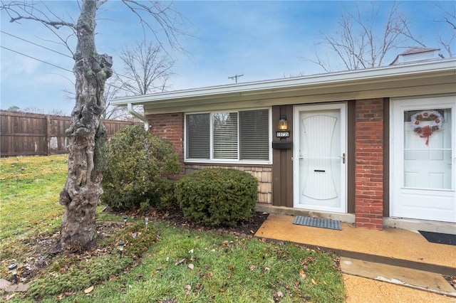 doorway to property featuring a lawn