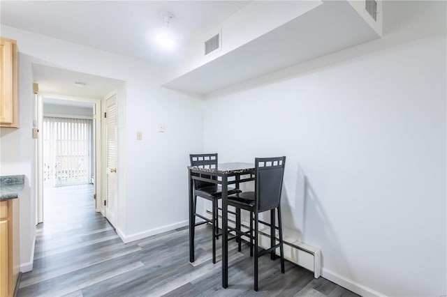 dining area with dark wood-type flooring