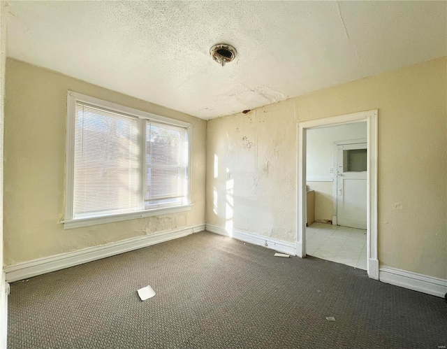 unfurnished bedroom with carpet and a textured ceiling