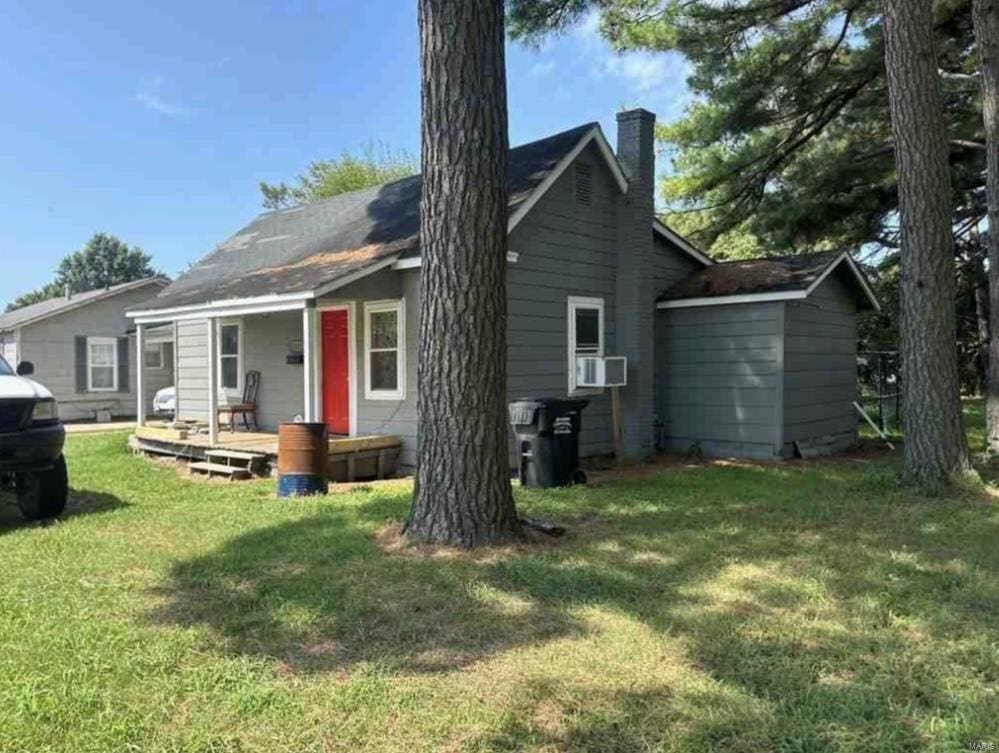 rear view of house featuring a yard and cooling unit