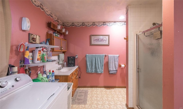 clothes washing area with independent washer and dryer and sink