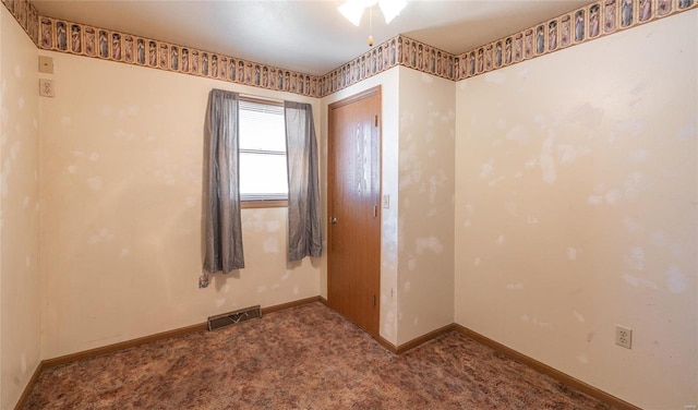 spare room featuring carpet floors and ceiling fan