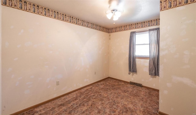 carpeted empty room featuring ceiling fan