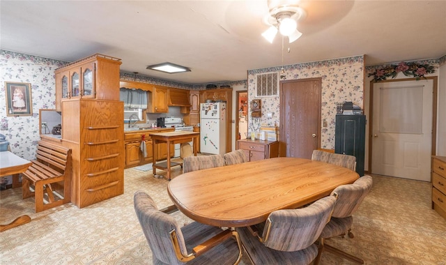 dining area featuring ceiling fan and sink