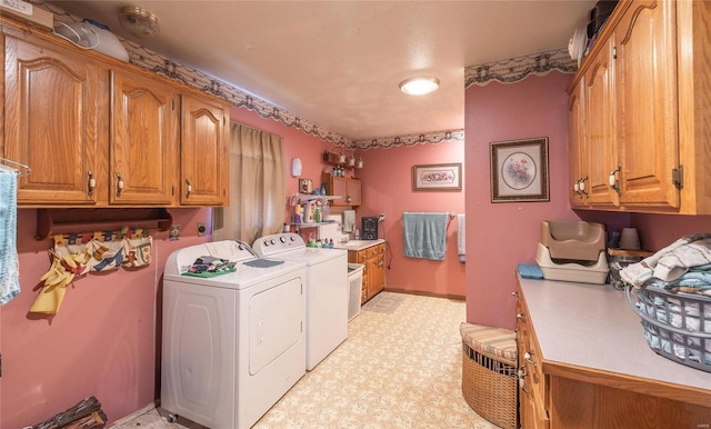 washroom featuring washer and dryer and cabinets