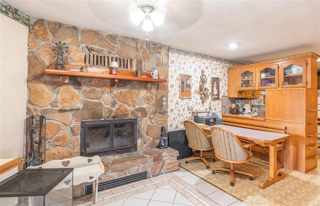 tiled office with ceiling fan and a fireplace