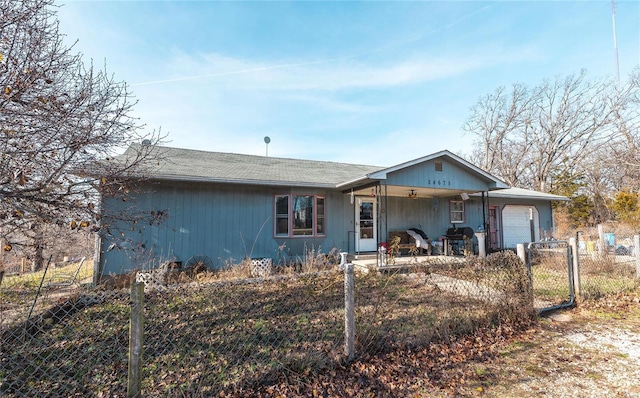 ranch-style house featuring covered porch and a garage