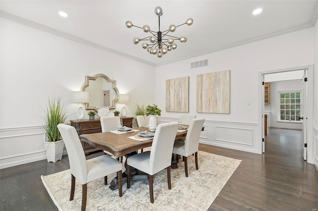 dining area with a notable chandelier, dark hardwood / wood-style floors, and crown molding