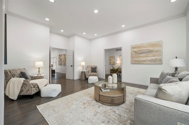 living room with dark wood-type flooring and crown molding