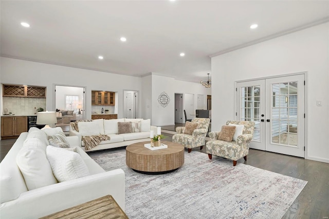 living room with french doors, dark hardwood / wood-style flooring, and ornamental molding