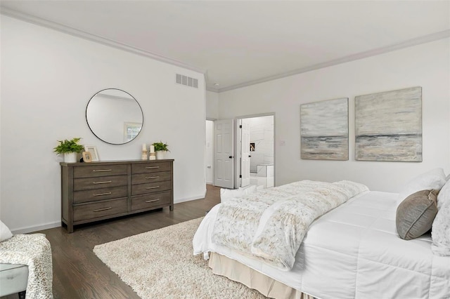 bedroom featuring dark hardwood / wood-style floors, ensuite bathroom, and crown molding