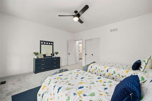 carpeted bedroom featuring a closet and ceiling fan