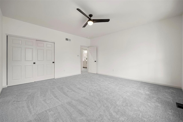 unfurnished bedroom with carpet flooring, a closet, and ceiling fan