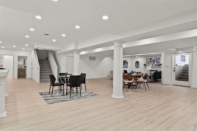 dining area featuring a fireplace and light hardwood / wood-style flooring