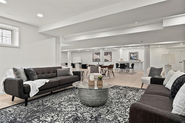 living room featuring decorative columns and hardwood / wood-style floors