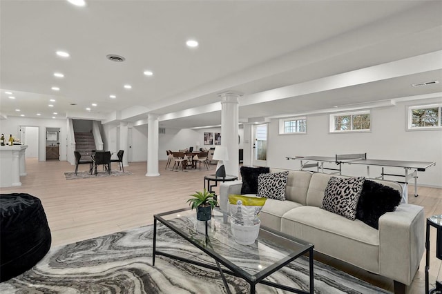 living room featuring light hardwood / wood-style floors and a healthy amount of sunlight