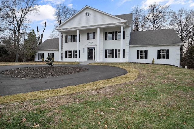 neoclassical home with a front yard