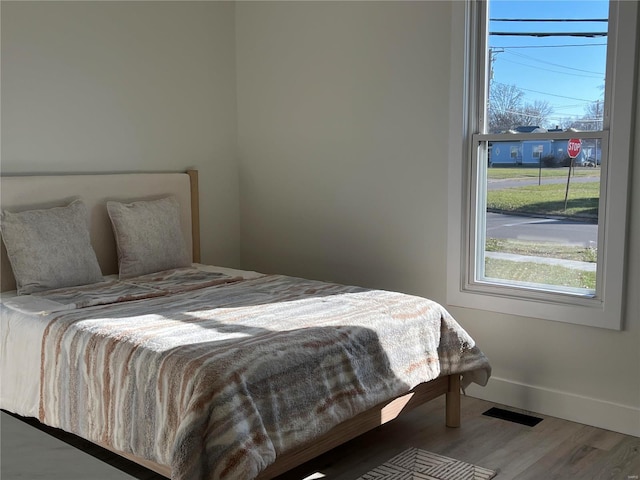 bedroom with hardwood / wood-style flooring