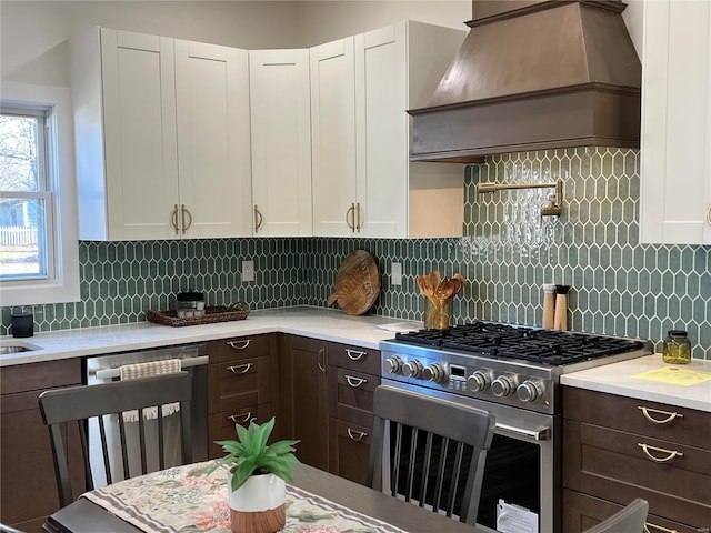 kitchen featuring appliances with stainless steel finishes, tasteful backsplash, white cabinetry, and dark brown cabinets