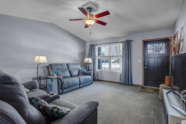 carpeted living room featuring ceiling fan, lofted ceiling, and a textured ceiling