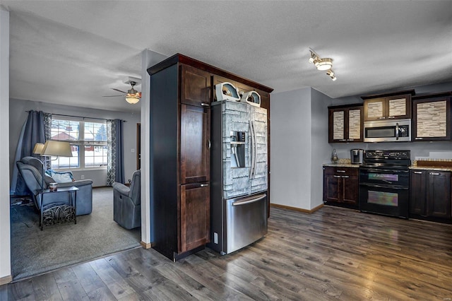 kitchen featuring ceiling fan, appliances with stainless steel finishes, dark hardwood / wood-style floors, and a textured ceiling