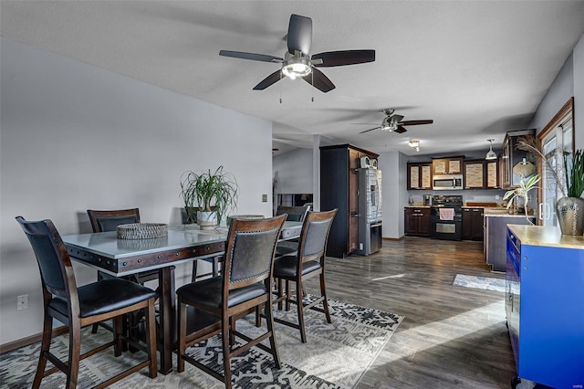 dining area featuring dark hardwood / wood-style flooring and a textured ceiling