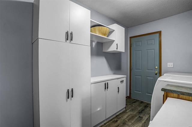 washroom featuring dark hardwood / wood-style flooring, washer / clothes dryer, cabinets, and a textured ceiling