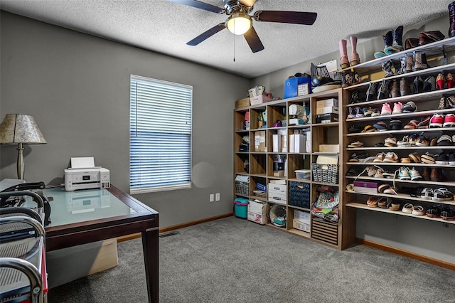 carpeted office space with ceiling fan, a wealth of natural light, and a textured ceiling