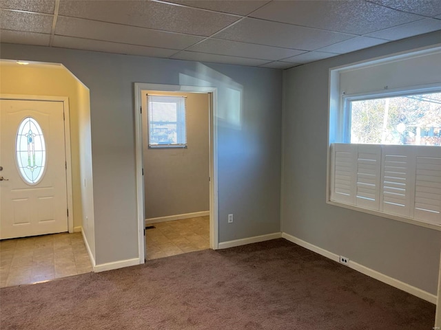 entryway with light carpet and a drop ceiling