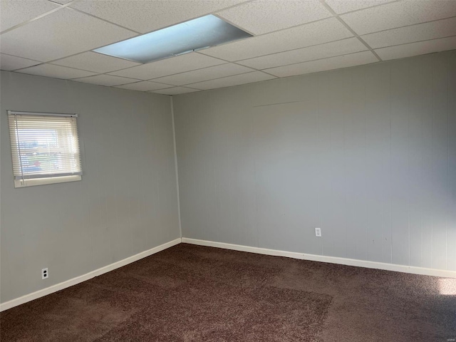 carpeted spare room featuring a paneled ceiling