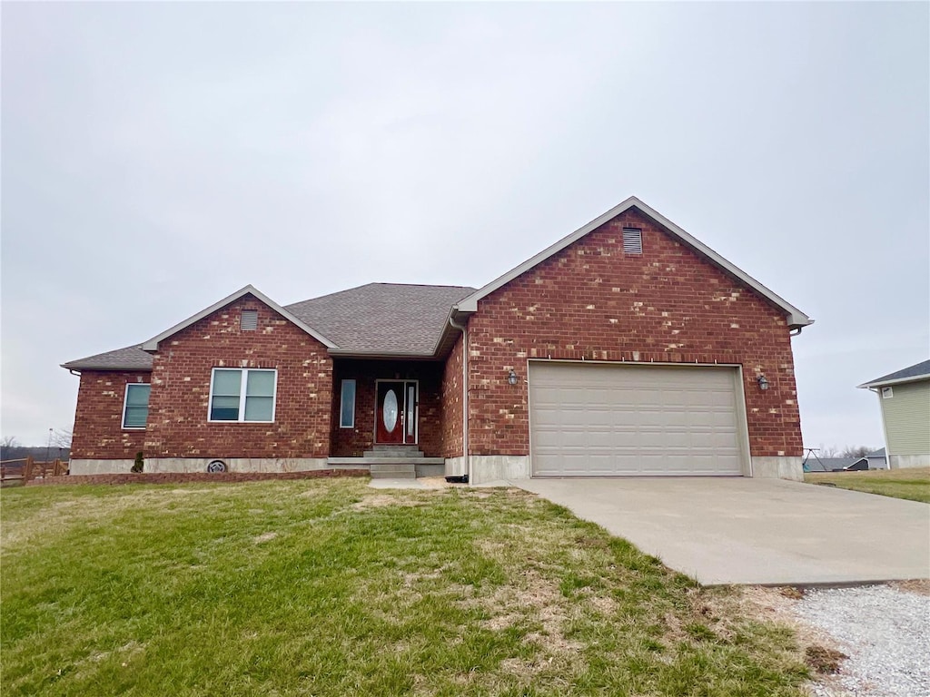 view of front of property featuring a garage and a front lawn