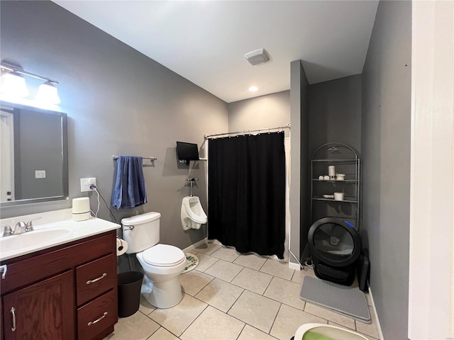 bathroom featuring tile patterned flooring, vanity, curtained shower, and toilet