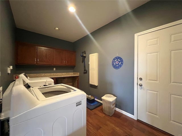 clothes washing area with cabinets, washer and dryer, and dark hardwood / wood-style floors