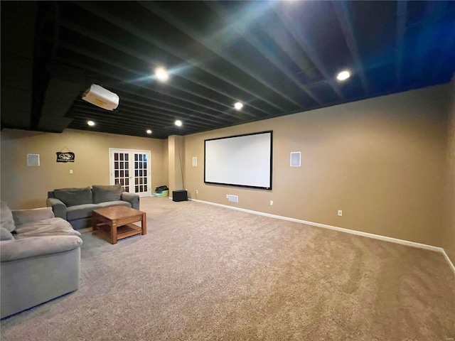 carpeted cinema room featuring french doors