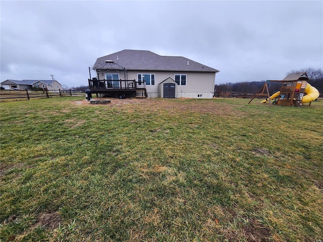 view of yard with a playground, a wooden deck, a gazebo, and a shed